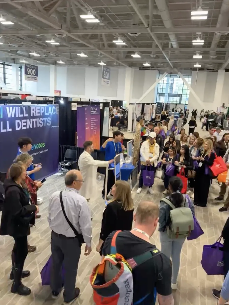 A large crowd of attendees surrounding the CareNotes booth at PNDC 2025